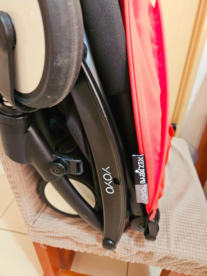 Babyzen Yoyo Stroller (Category: Strollers) located in Manila. Submitted by teilybam (Listing ID 1431782973, Image 3). Description: - Babyzen Yoyo stroller - Color: Black frame, red canopy - Features: Comfortable seat, white wheels - Design: Compact and foldable for easy storage - Includes: Hook attachment for accessories - Ideal for parents on the go.
