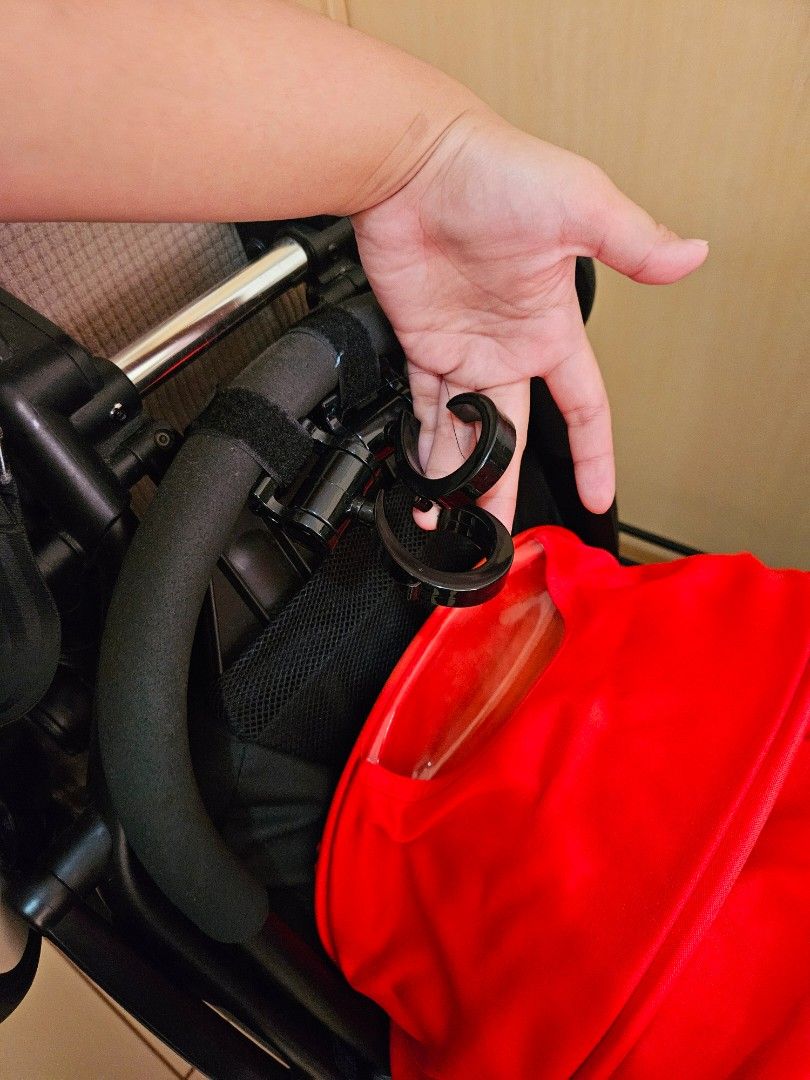 Babyzen Yoyo Stroller (Category: Strollers) located in Manila. Submitted by teilybam (Listing ID 1431782973, Image 2). Description: - Babyzen Yoyo stroller - Color: Black frame, red canopy - Features: Comfortable seat, white wheels - Design: Compact and foldable for easy storage - Includes: Hook attachment for accessories - Ideal for parents on the go.