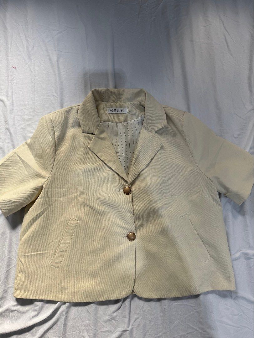 Beige Vest with Gold Buttons - Size M (Category: Sleeveless) located in Manila. Submitted by raphaelain17296 (Listing ID 1431735498, Image 1). Description: - Beige vest - Features two gold buttons - Includes two front pockets - Striped lining - Size: M - Brand tag in Chinese characters.