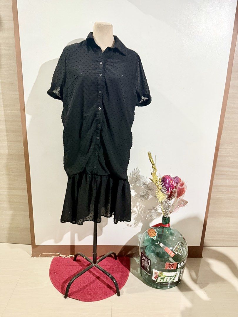 Black Button-Down Dress (Category: Dresses) located in Caloocan City. Submitted by dddddddddddeclutter (Listing ID 1431756196, Image 1). Description: - Black dress - Button-down design - Short sleeves - Collared neckline - Gathered waist detail - Ruffled hem - Subtle dotted texture - Chic and versatile.