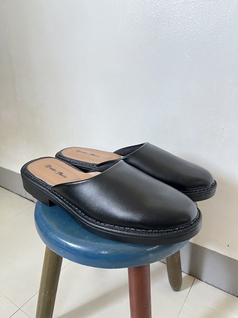 Black Leather Mules (Category: Dress Shoes) located in Las Pinas. Submitted by solfits (Listing ID 1431606639, Image 1). Description: [brand new] black synthetic leather mules * haven't worn them outside * size 44 (27cm) * glue/adhesive aren't that neat (brought from an indonesian brand on 🍊) * overall condition is great * no box inclusion.