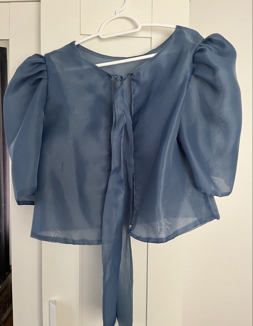Blue Puff Sleeve Blouse (Category: Blouses) located in Quezon City. Submitted by findingthingzzz (Listing ID 1431615471, Image 2). Description: - Elegant blue blouse - Features puff sleeves and tie detail - Sheer, lightweight fabric - Round neckline - Relaxed fit - Perfect for various occasions I bought this in Kultura for graduation ceremony. .