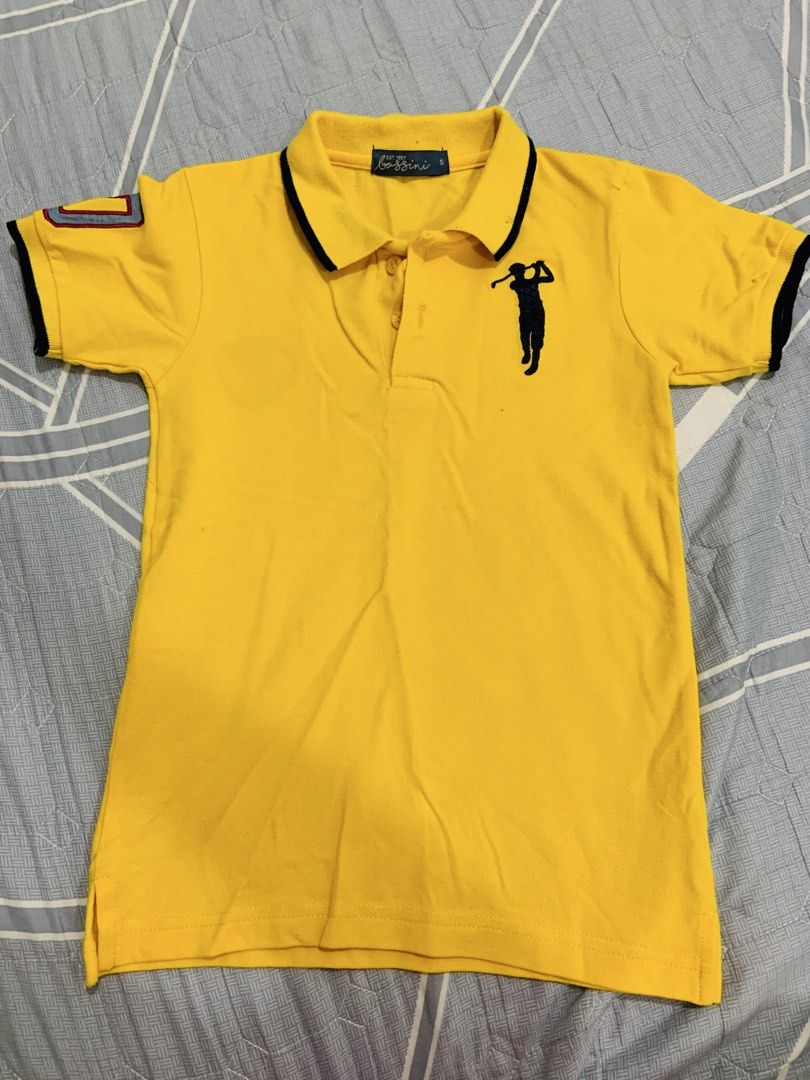 Bossini Yellow Polo Shirt (Category: Babies & Kids Fashion) located in Rizal. Submitted by itsmecarebear (Listing ID 1431583051, Image 1). Description: - Yellow Bossini polo shirt - Golf player design - Black collar and sleeve trim - Small size - Comfortable material - Button-up placket - Short sleeves - Patch on left sleeve.