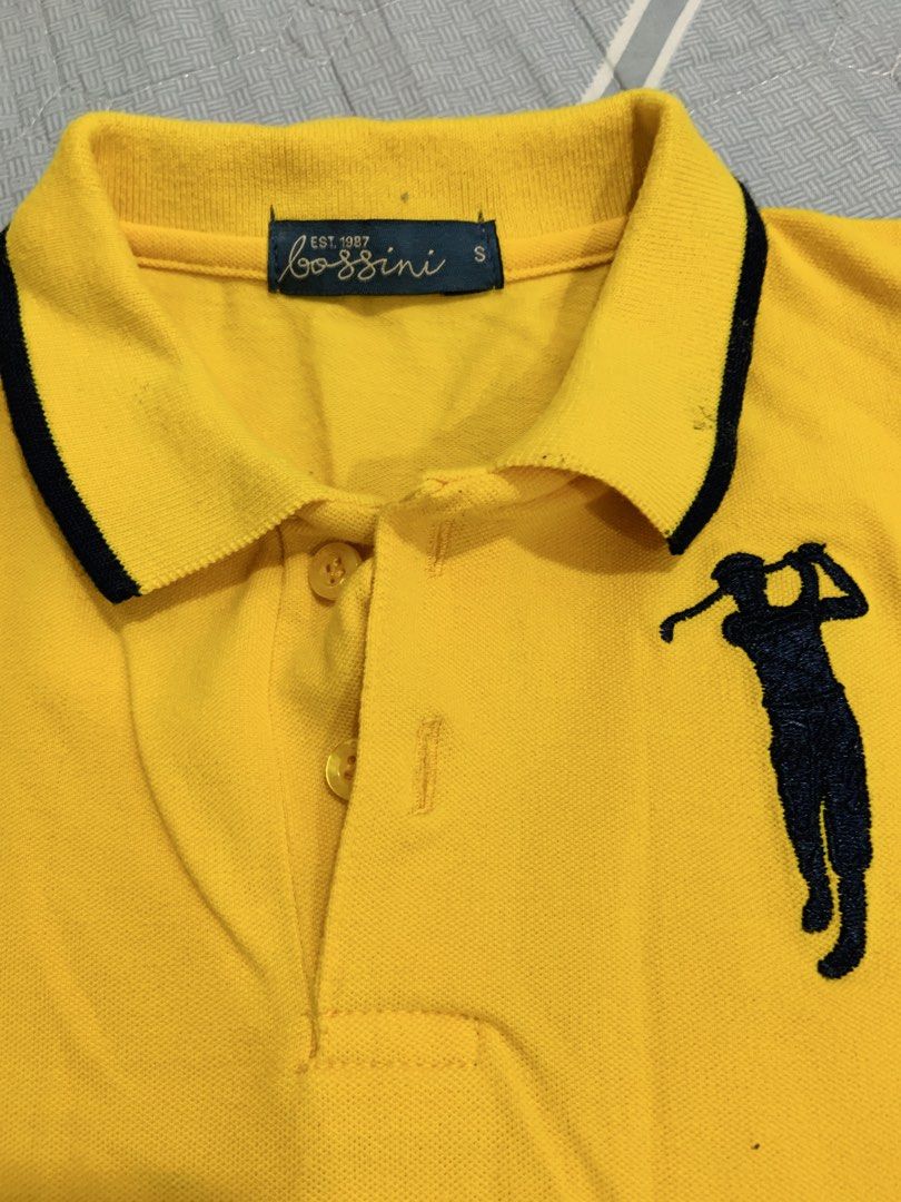 Bossini Yellow Polo Shirt (Category: Babies & Kids Fashion) located in Rizal. Submitted by itsmecarebear (Listing ID 1431583051, Image 2). Description: - Yellow Bossini polo shirt - Golf player design - Black collar and sleeve trim - Small size - Comfortable material - Button-up placket - Short sleeves - Patch on left sleeve.
