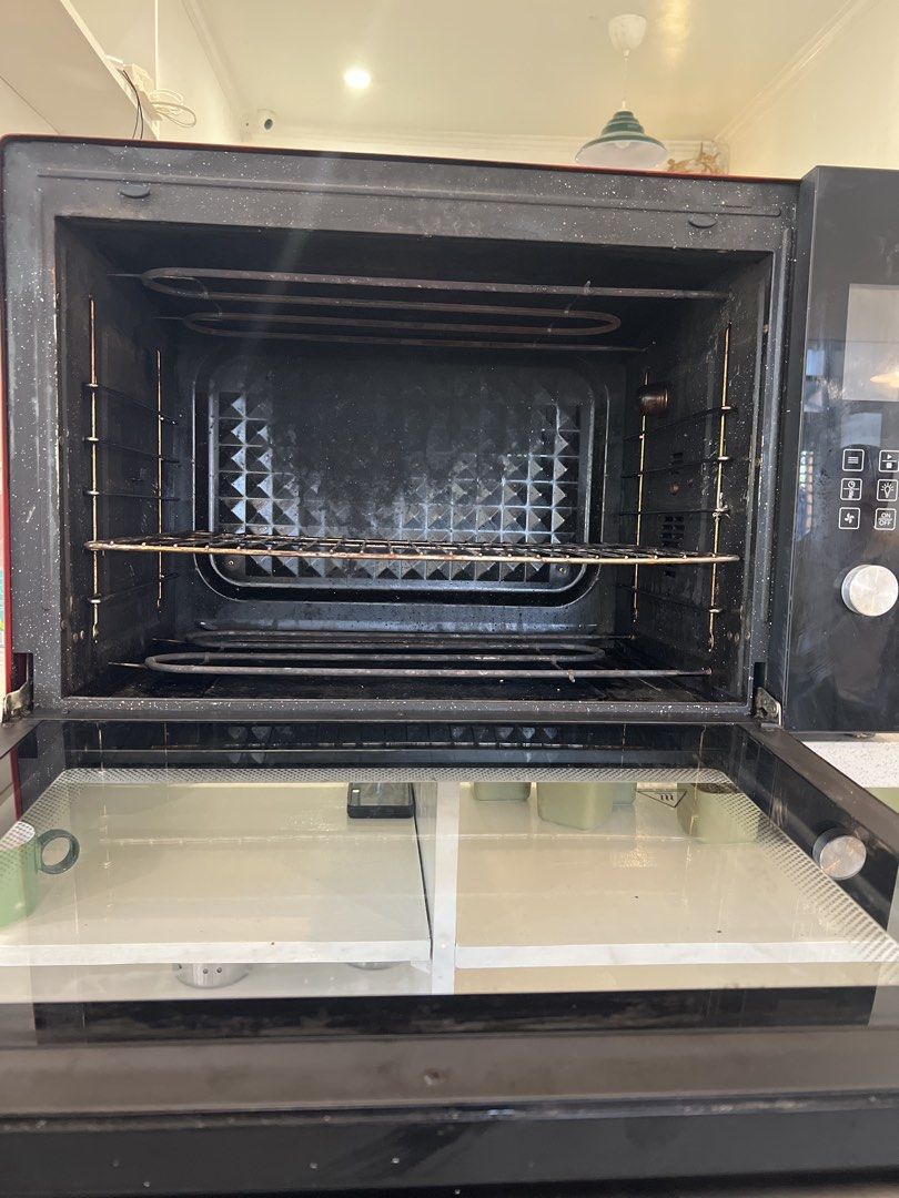 Brikk Microwave Oven 100 liters (Category: Ovens & Toasters) located in Manila. Submitted by lifestylers.media (Listing ID 1431673448, Image 3). Description: - Brikk microwave oven 100liters - Black and red exterior with glass door - Silver back - Includes rack and heating elements - Control panel with multiple settings - In good working condition.