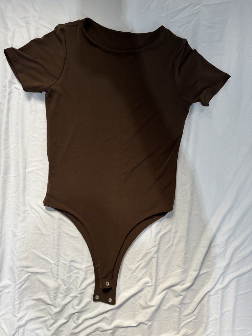 Brown Short Sleeve Bodysuit (Category: Others Tops) located in Manila. Submitted by raphaelain17296 (Listing ID 1431736227, Image 2). Description: - Brown bodysuit - Short sleeves - Scoop neckline - Snap closures at the bottom - Smooth, stretchy fabric - Versatile for various occasions.