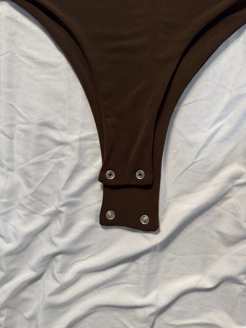 Brown Short Sleeve Bodysuit (Category: Others Tops) located in Manila. Submitted by raphaelain17296 (Listing ID 1431736227, Image 3). Description: - Brown bodysuit - Short sleeves - Scoop neckline - Snap closures at the bottom - Smooth, stretchy fabric - Versatile for various occasions.