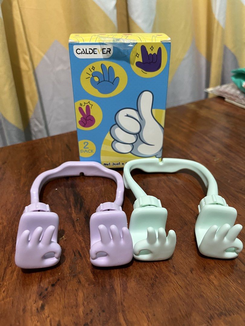 Caldever Hand Gesture Phone Stand (Category: Mounts & Holders) located in Daet. Submitted by UkayanNiAnj (Listing ID 1431572808, Image 1). Description: - Caldever phone stand with a unique hand gesture design. - Offers 360-degree rotation for flexible viewing. - Adjustable angles for optimal phone positioning. - Special slot design ensures unobstructed full-screen viewing. - Supports both vertical and horizontal phone orientations. - Available in