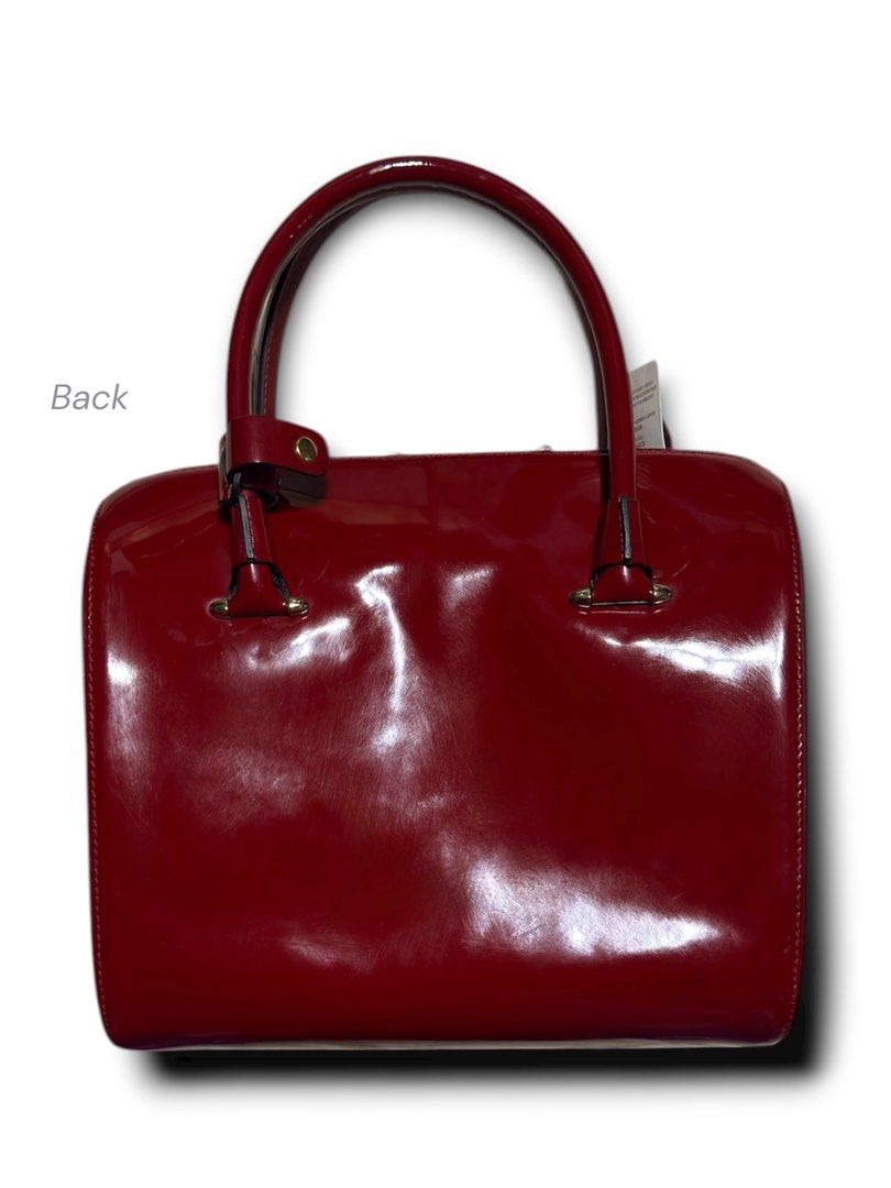Cartier Red Patent Leather Handbag (Category: Luxury Bags & Wallets) located in Cebu City. Submitted by gabgaaab (Listing ID 1431613549, Image 3). Description: Cartier Marcello de Cartier Patent Leather Bowling Bag - Excellent Condition - Patent Calfskin Leather (Exterior); Knapp Finished Leather (Interior) - Color: Bordeaux / Ruby Red - Hardware: Gold-finish hardware with signature Double C logo zipper pulls - Interior: Neutral textile lining wi