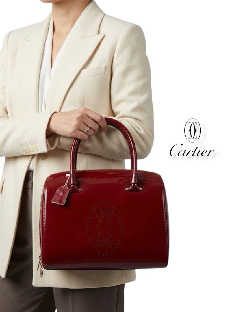 Cartier Red Patent Leather Handbag (Category: Luxury Bags & Wallets) located in Cebu City. Submitted by gabgaaab (Listing ID 1431613549, Image 1). Description: Cartier Marcello de Cartier Patent Leather Bowling Bag - Excellent Condition - Patent Calfskin Leather (Exterior); Knapp Finished Leather (Interior) - Color: Bordeaux / Ruby Red - Hardware: Gold-finish hardware with signature Double C logo zipper pulls - Interior: Neutral textile lining wi