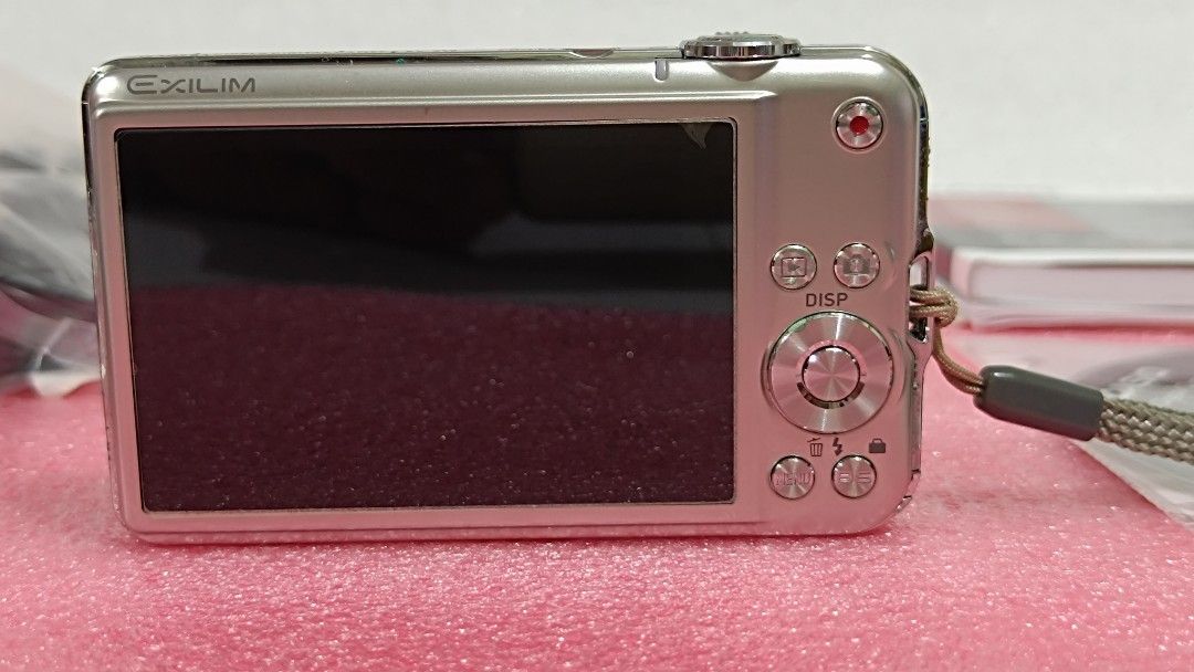 Casio Exilim EX-S12 Digital Camera (Category: Cameras) located in Baguio. Submitted by preloved_corner37 (Listing ID 1431655020, Image 3). Description: - Casio Exilim EX-S12 digital camera - Includes original box, manuals, and accessories - Comes with charger, cables, and CD - Silver color - Features a wrist strap.