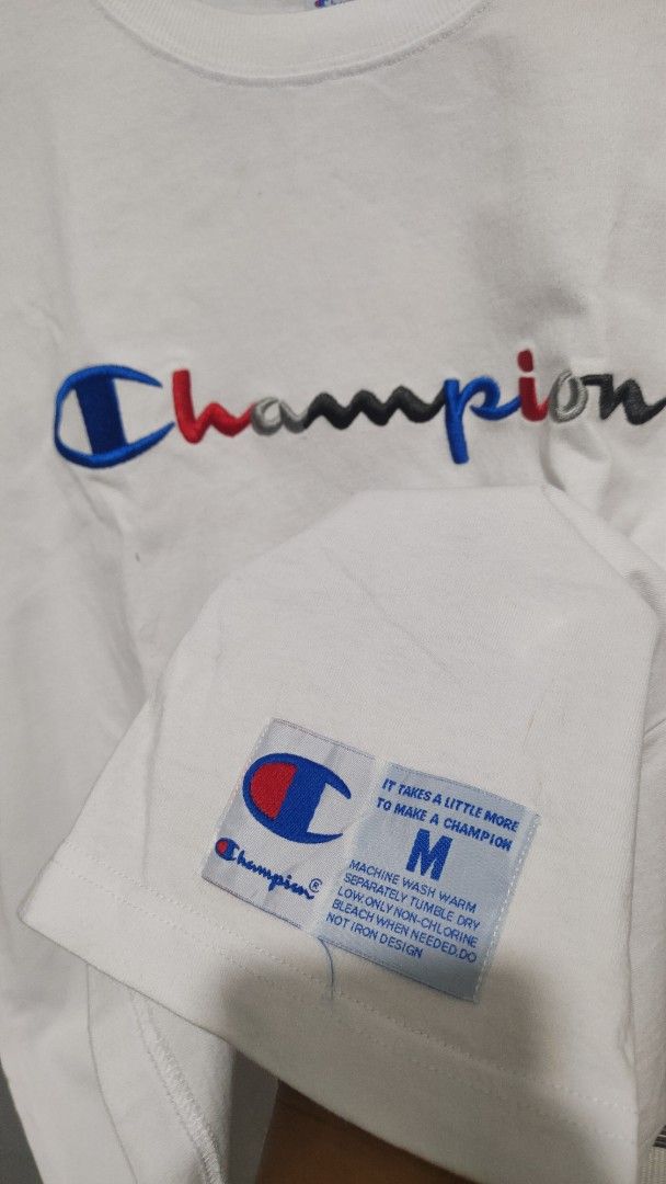 Champion T-shirt - White - Medium (Category: Tshirts & Polo Shirts ) located in Cavite. Submitted by trend27 (Listing ID 1431774211, Image 2). Description: - Champion white t-shirt - Size: Medium 20/25 need wash only - Crew neck and short sleeves - Champion logo on front and sleeve - Material: 100% cotton - Includes care instructions.