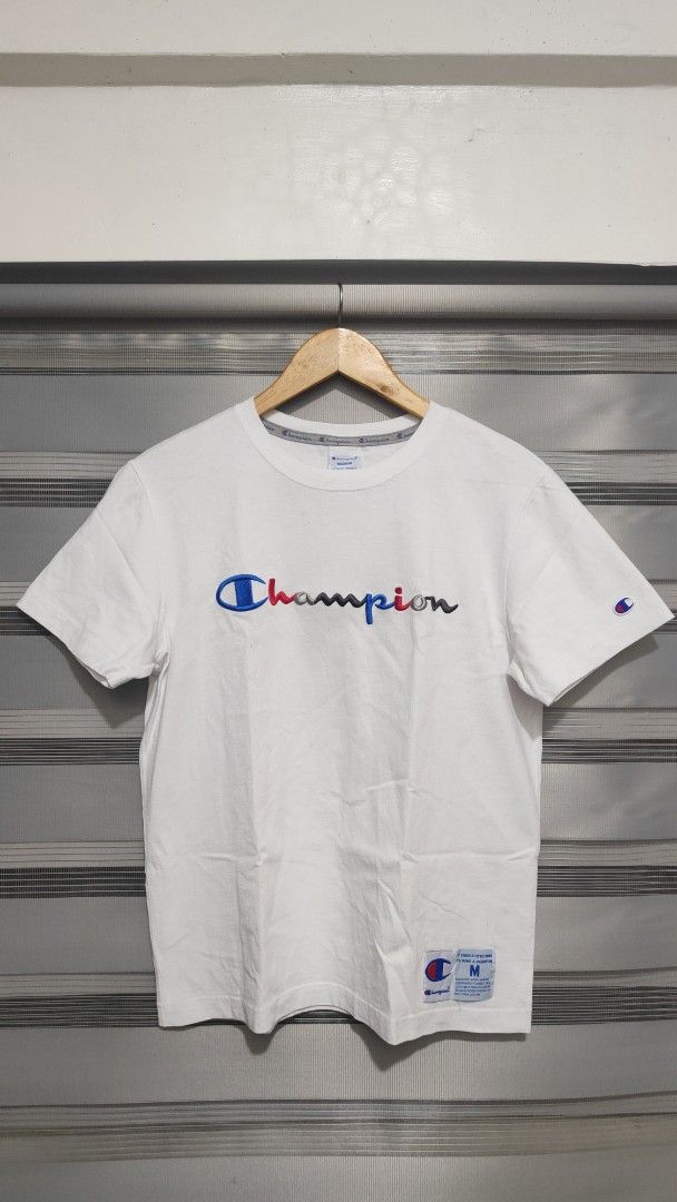 Champion T-shirt - White - Medium (Category: Tshirts & Polo Shirts ) located in Cavite. Submitted by trend27 (Listing ID 1431774211, Image 1). Description: - Champion white t-shirt - Size: Medium 20/25 need wash only - Crew neck and short sleeves - Champion logo on front and sleeve - Material: 100% cotton - Includes care instructions.