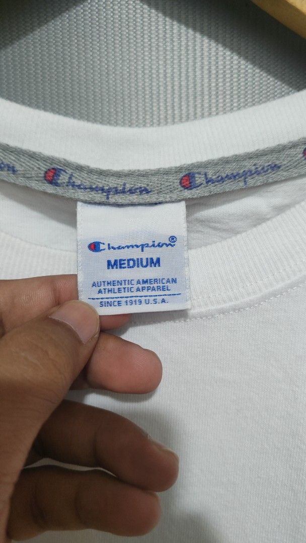 Champion T-shirt - White - Medium (Category: Tshirts & Polo Shirts ) located in Cavite. Submitted by trend27 (Listing ID 1431774211, Image 3). Description: - Champion white t-shirt - Size: Medium 20/25 need wash only - Crew neck and short sleeves - Champion logo on front and sleeve - Material: 100% cotton - Includes care instructions.