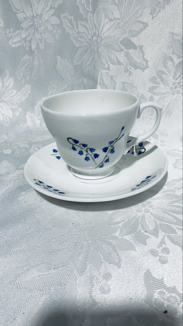 Collectible ceramic teacup and saucer set (Category: Coffee & Tea Tableware) located in Quezon City. Submitted by smithram (Listing ID 1431746296, Image 3). Description: - Hand painted - Forest Originals teacup and saucer set - White base with blue floral accents - Delicate cup handle - Matching saucer design - Hand signed brand name and "2000" visible on both pieces - Perfect for tea or coffee.