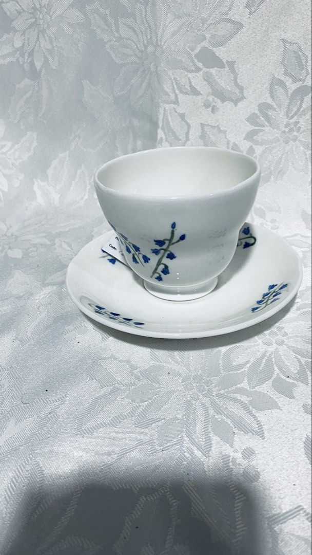 Collectible ceramic teacup and saucer set (Category: Coffee & Tea Tableware) located in Quezon City. Submitted by smithram (Listing ID 1431746296, Image 2). Description: - Hand painted - Forest Originals teacup and saucer set - White base with blue floral accents - Delicate cup handle - Matching saucer design - Hand signed brand name and "2000" visible on both pieces - Perfect for tea or coffee.