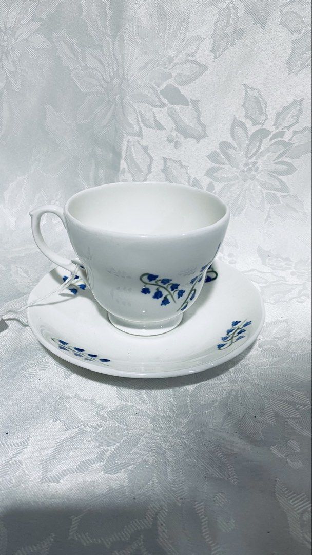 Collectible ceramic teacup and saucer set (Category: Coffee & Tea Tableware) located in Quezon City. Submitted by smithram (Listing ID 1431746296, Image 1). Description: - Hand painted - Forest Originals teacup and saucer set - White base with blue floral accents - Delicate cup handle - Matching saucer design - Hand signed brand name and "2000" visible on both pieces - Perfect for tea or coffee.