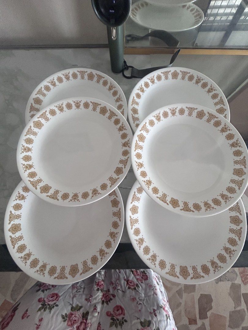 Corelle Dinner Plates with Floral Design 450 each (Category: Dinnerware & Cutlery) located in Lubao. Submitted by appleglaze (Listing ID 1431621928, Image 1). Description: - Corelle dinner plates - White with gold floral pattern - Lightweight and durable - Perfect for everyday use or special occasions - Corelle logo visible.