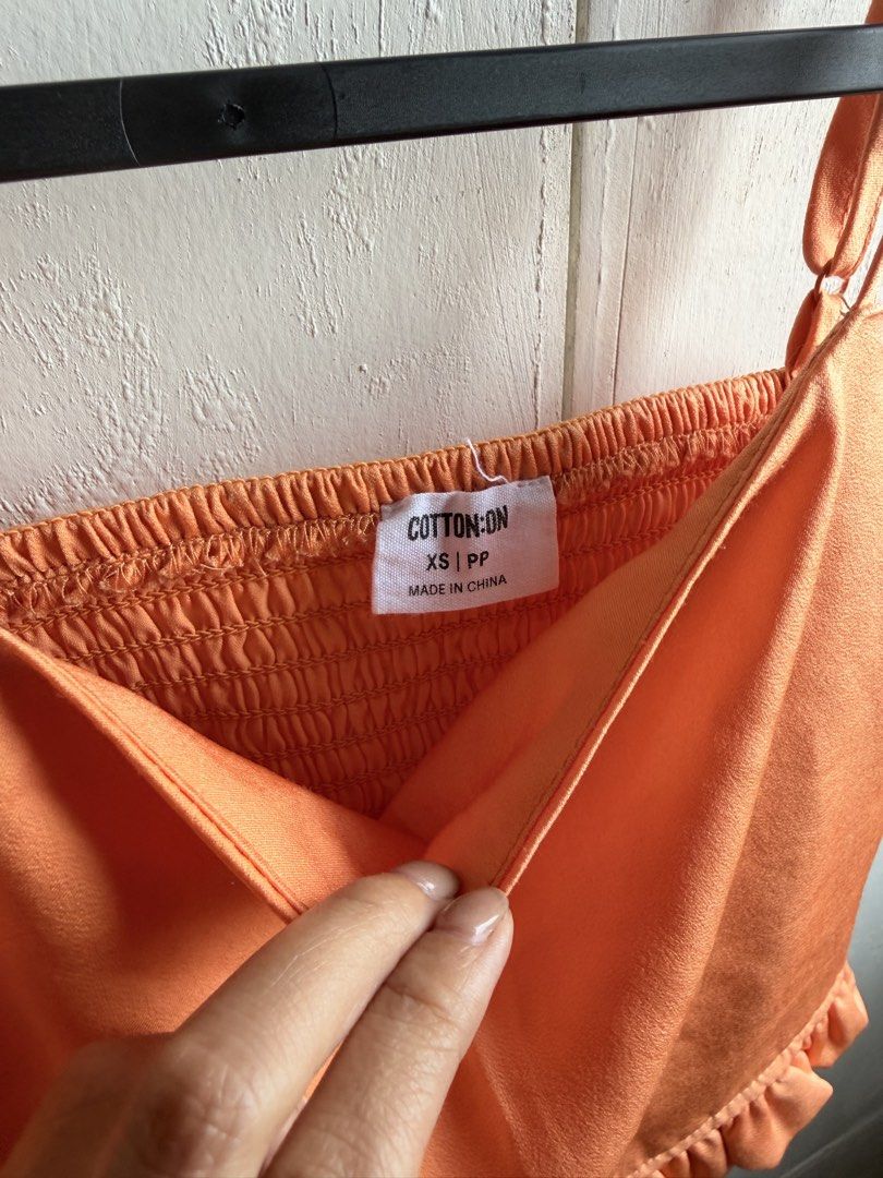 Cotton On Crop Top Stretchy Back and Adjustable Straps (Category: Sleeveless) located in Manila. Submitted by shee_decluttering (Listing ID 1431616646, Image 2). Description: Worn only twice maybe thrice Not into crop tops anymore Last photo is inspo when worn only Size is XS and in color orange.