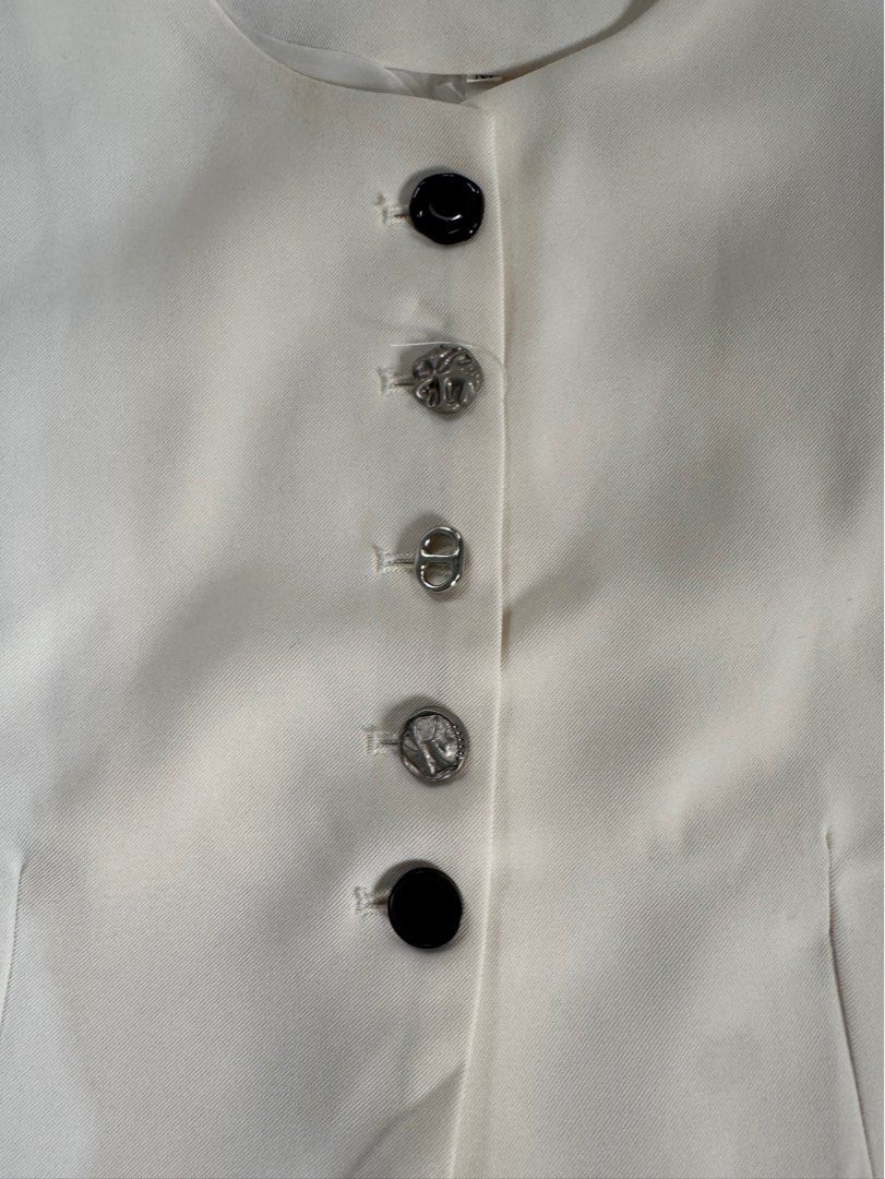 Cream-colored Vest with Buttons - Size M (Category: Sleeveless) located in Manila. Submitted by raphaelain17296 (Listing ID 1431732902, Image 2). Description: - Cream-colored vest - Size Semi large - Round neckline - Two front pockets - Decorative buttons - Visible lining.