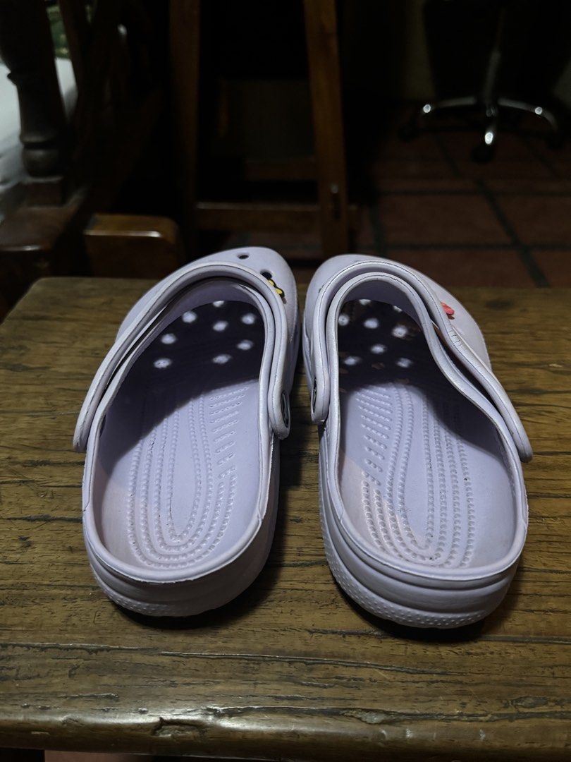 Crocs Lavender Clogs with Jibbitz - Size M3/W5 (Category: Slippers and slides) located in Quezon City. Submitted by limebasil (Listing ID 1431739605, Image 3). Description: - Lavender Crocs clogs - Includes butterfly, strawberry, and paw print Jibbitz charms - Size: W5/M3 - Made in China - Features Crocs logo on side and top - Textured soles.