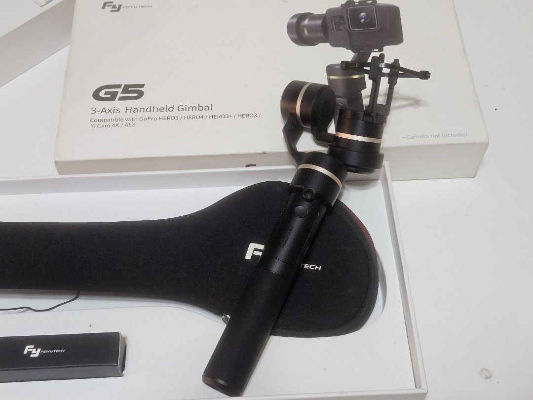 FeiyuTech G5 3-Axis Handheld Gimbal (Category: Gimbals & Stabilizers ) located in Las Pinas. Submitted by jcprillo0508 (Listing ID 1431788673, Image 2). Description: - FeiyuTech G5 3-Axis Handheld Gimbal - Compatible with GoPro HERO4/HERO3+/HERO3 and Yi Cam 4K/4K+ - Comes with a carrying case - Includes a small accessory box - Stylish black and gold color - Box image shows gimbal with camera mounted.