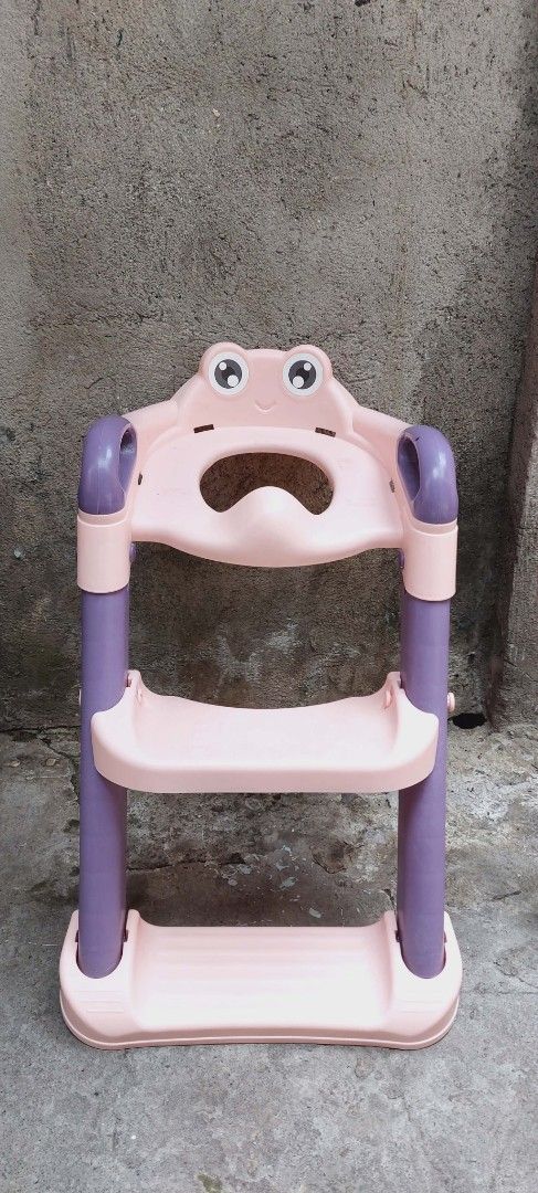 Potty Training Frog-Shaped Step Stool (Category: Chairs) located in Quezon City. Submitted by mkesimsa_six67 (Listing ID 1431592576, Image 1). Description: - Adorable frog design - Two-step stool - Features safety handles - Pink with purple accents - Made of durable plastic - Ideal for young children - Helps kids reach elevated surfaces like sinks.