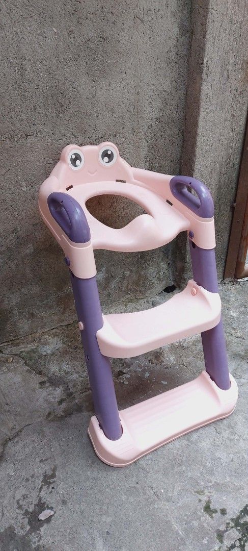 Potty Training Frog-Shaped Step Stool (Category: Chairs) located in Quezon City. Submitted by mkesimsa_six67 (Listing ID 1431592576, Image 2). Description: - Adorable frog design - Two-step stool - Features safety handles - Pink with purple accents - Made of durable plastic - Ideal for young children - Helps kids reach elevated surfaces like sinks.