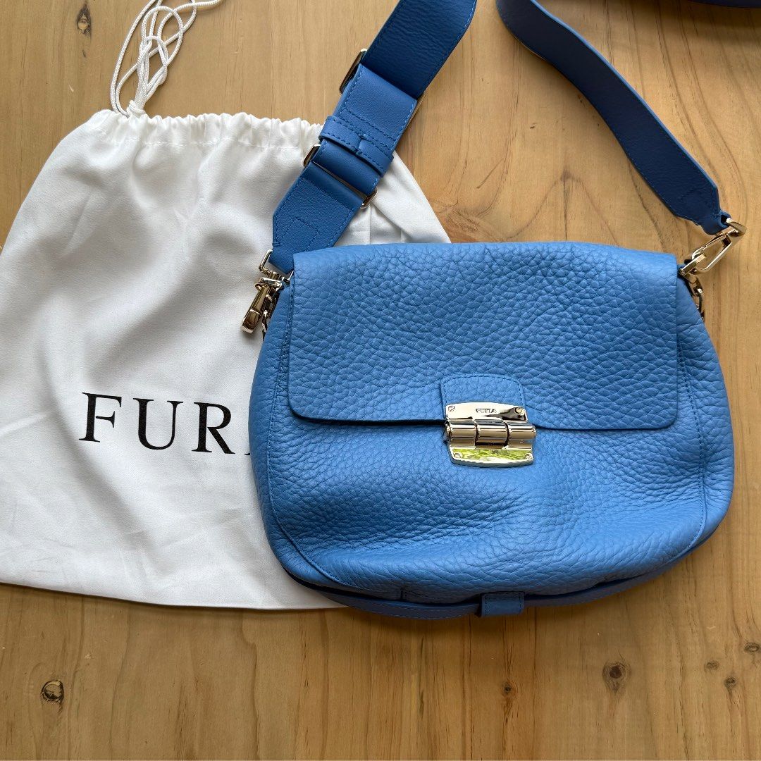 Furla Metropolis Crossbody Bag - Blue (Category: Luxury Bags & Wallets) located in Calamba. Submitted by letsygread9 (Listing ID 1431672948, Image 1). Description: - Authentic Furla Metropolis crossbody bag - Beautiful blue color - Gold-tone clasp and hardware - Includes dust bag and care card - Textured leather exterior - Adjustable strap - Clean interior - Stylish and functional.