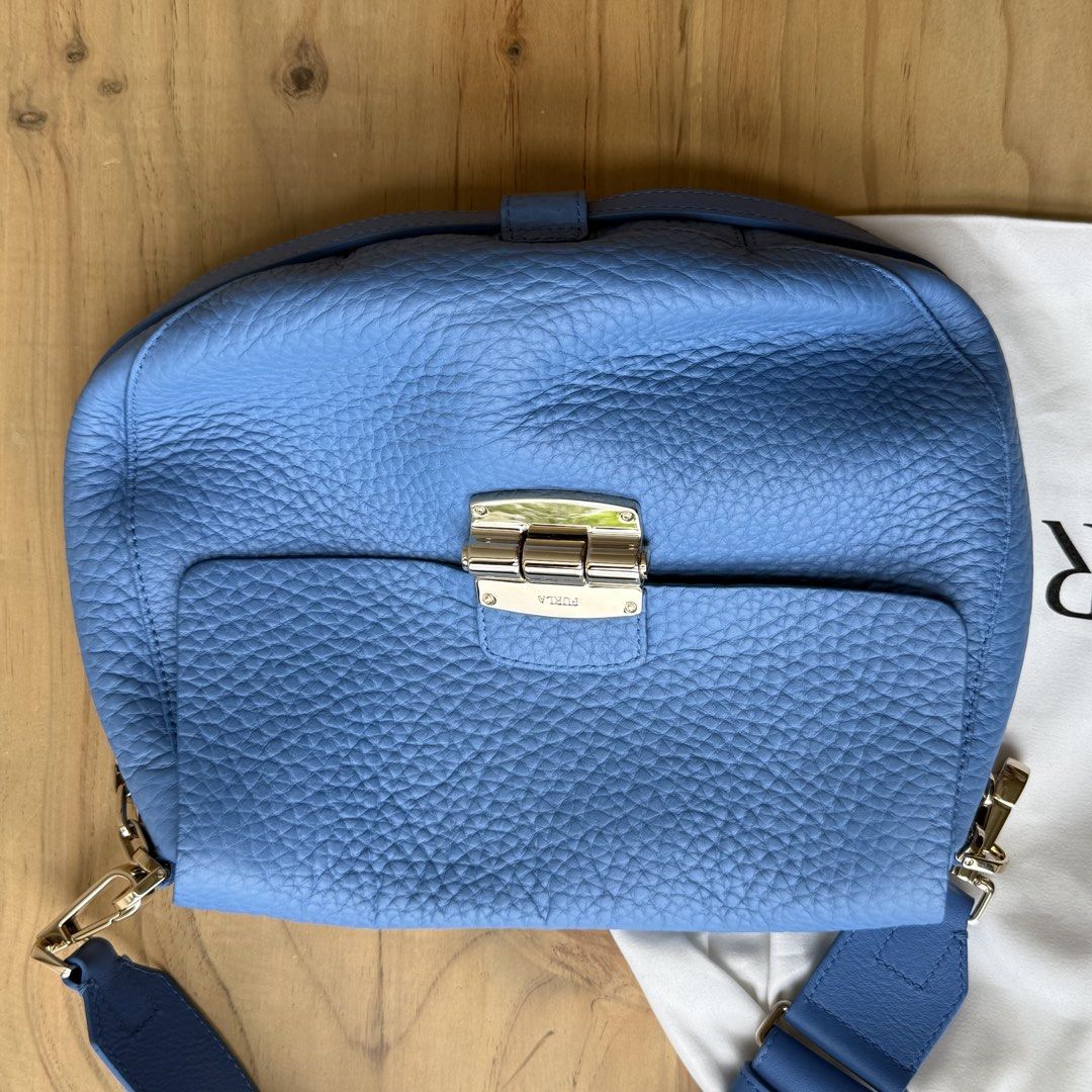 Furla Metropolis Crossbody Bag - Blue (Category: Luxury Bags & Wallets) located in Calamba. Submitted by letsygread9 (Listing ID 1431672948, Image 2). Description: - Authentic Furla Metropolis crossbody bag - Beautiful blue color - Gold-tone clasp and hardware - Includes dust bag and care card - Textured leather exterior - Adjustable strap - Clean interior - Stylish and functional.