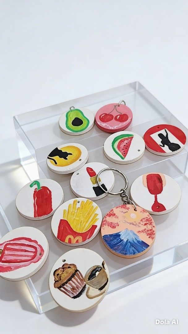 Hand-painted Food and Scenery Keychains (Category: Handmade Craft) located in Cavite. Submitted by joycreates (Listing ID 1431788467, Image 1). Description: - Hand-painted wooden keychains - Features food items (avocado, cherries, etc.) and scenery (mountains) - Round shape with colorful designs - Perfect for keys or bags -Perfect for gifts and giveaways.