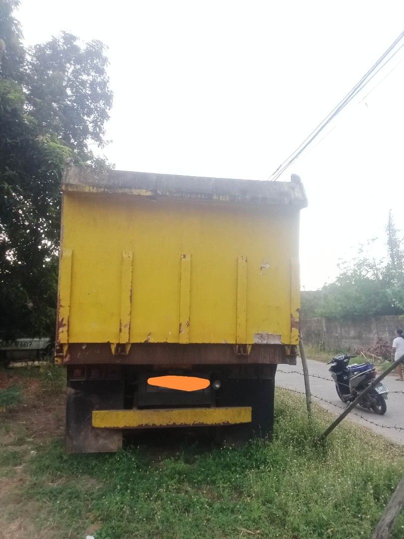 Isuzu Dump Truck (Category: Heavy Vehicles) located in Manila. Submitted by cheapcellphone (Listing ID 1431607711, Image 2). Description: ISUZU GIGA 10w DUMP TRUCK ENGINE 10Pe BUTTERFLY BOOM SARIWA PA ANG CHASIS AT ENGINE MANUAL TRANSMISSION 7-SPEED YELLOW PAMPANGA LOCATION RFS: NEED MONEY FOR HOSPITAL BILLS FOR SALE FOR 1M FIX PRICE Yellow Isuzu dump truck. Features a large cargo bed and a cab with side mirrors. The truck has a visible Isuzu log