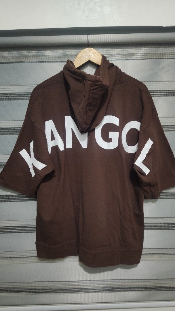 Kangol Short Sleeve Hoodie (Category: Coats, Jackets and Outerwear) located in Cavite. Submitted by trend27 (Listing ID 1431771311, Image 1). Description: - Kangol Brown Short Sleeve Hoodie - Size: Large 23/28 - Features Kangol logo on front - Brand name printed on the back - With hood - Kangaroo pocket.