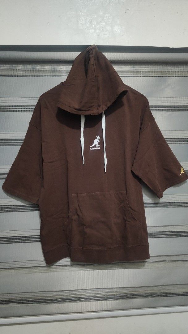 Kangol Short Sleeve Hoodie (Category: Coats, Jackets and Outerwear) located in Cavite. Submitted by trend27 (Listing ID 1431771311, Image 2). Description: - Kangol Brown Short Sleeve Hoodie - Size: Large 23/28 - Features Kangol logo on front - Brand name printed on the back - With hood - Kangaroo pocket.