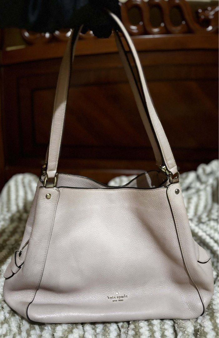 Kate Spade Leila Pink Shoulder Bag Original (Category: Luxury Bags & Wallets) located in Manila. Submitted by clearedandcherished (Listing ID 1431754722, Image 3). Description: Help me declutter! This is Kate Spade Leila in medium triple compartment shoder bag in soft pink. Features a top handle, shoulder strap, multiple compartments, and zipper closure. Gold-toned hardware. Interior with heart pattern. Includes Kate Spade New York logo. Buyer wi