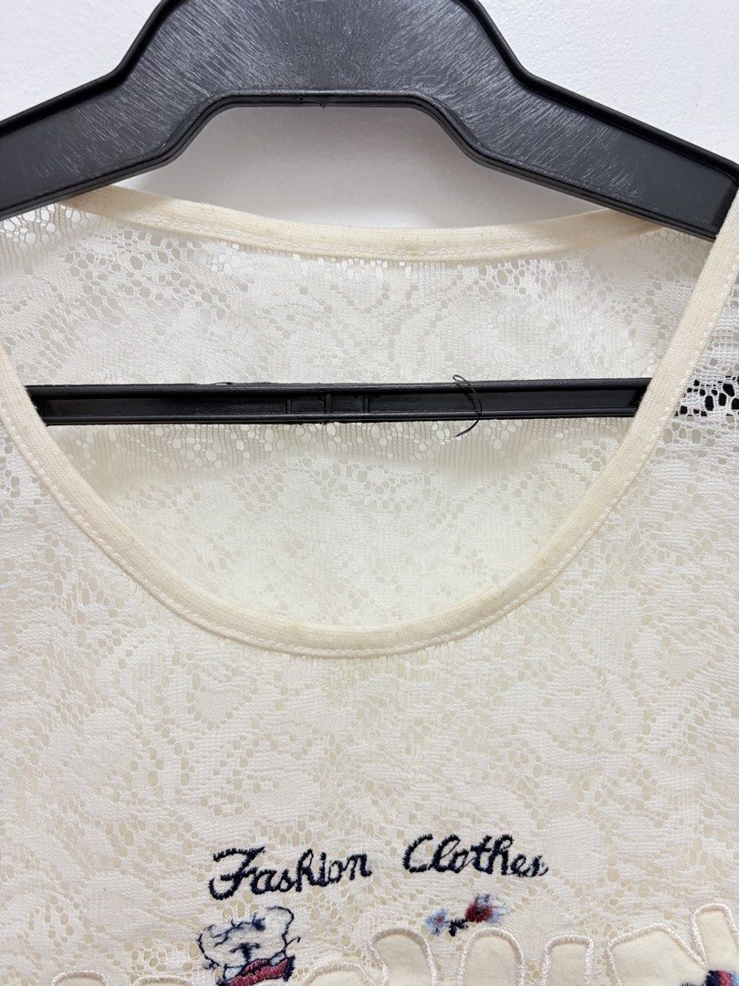 Lace Tank Top with Embroidery (Category: Sleeveless) located in Caloocan City. Submitted by nins___ (Listing ID 1431703744, Image 2). Description: - Cream-colored lace tank top - Features "Fashion Clothes" embroidered design with patches - Sleeveless design - Round neckline - Delicate lace pattern - Versatile for layering or wearing alone - Stylish and unique - Used but not abused. Price is still negotiable. Delivery fee will be shouldered by the