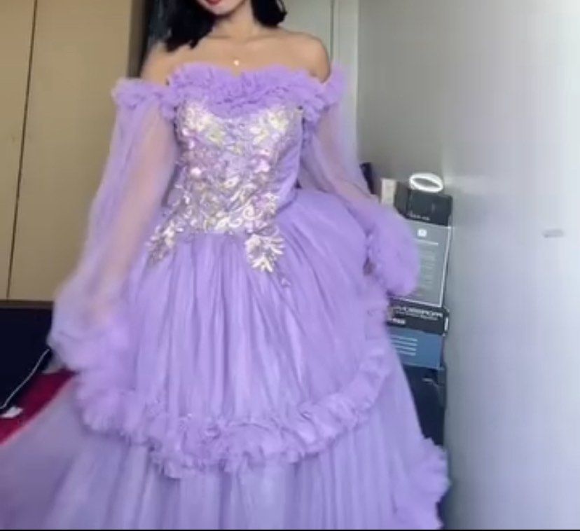 Lavender Off-Shoulder Princess Gown (Category: Evening dresses & gowns) located in Pasay City. Submitted by yang_mg21 (Listing ID 1431633167, Image 2). Description: Dreamy lavender gown with off-shoulder design, puff sleeves, and detailed embroidered bodice ✨ Flowy and super eye-catching — perfect for prom, debut, photoshoots, or special events. Gives soft princess/fairycore vibes 🧚‍♀️ Worn once, still in great condition. Minimal issue; may sira
