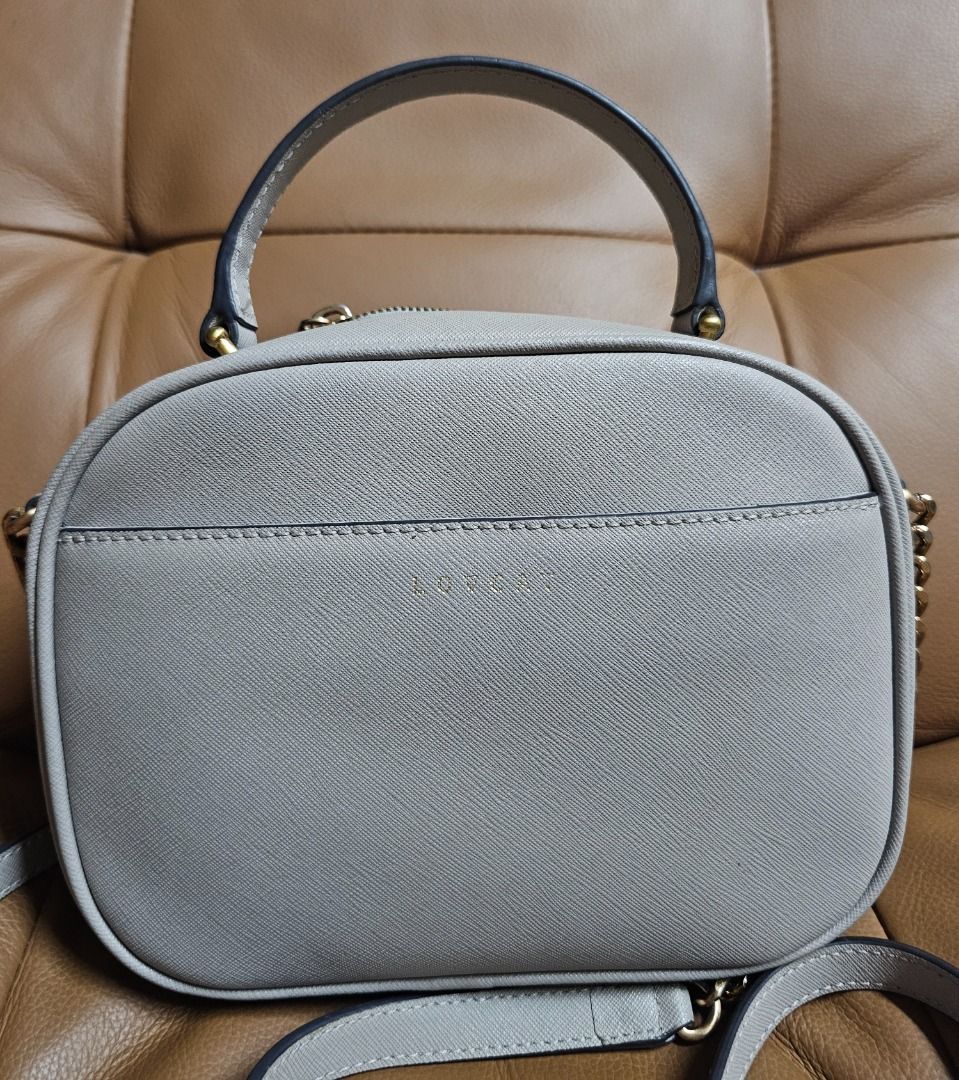 LOVCAT Paris Grey Handbag (Category: Luxury Bags & Wallets) located in Manila. Submitted by marsacovent (Listing ID 1431585952, Image 2). Description: - LOVCAT Paris handbag - Grey exterior - Top handle and detachable shoulder strap - Gold-toned zippers and hardware - Multiple interior compartments - LOVCAT logo on front.