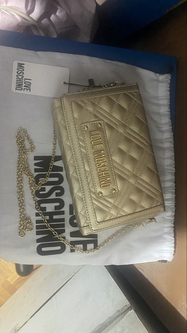 Love Moschino Quilted Shoulder Bag (Category: Luxury Bags & Wallets) located in Quezon City. Submitted by maismaria (Listing ID 1431611303, Image 2). Description: -Love Moschino shoulder bag - Quilted design - Gold chain strap - Love Moschino logo on front - Includes dust bag and tags - Black interior .