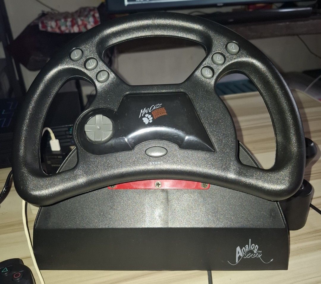 Mad catz analog steering wheel (Category: Controllers) located in Antipolo. Submitted by lakay_toys (Listing ID 1431591742, Image 2). Description: Mad catz analog steering wheel Complete in box Box in good condition Tested working Steering wheel working Gear shift and pedal working * tested games gran turismo and crash team racing ps1 games 3k Location lower antipolo city.
