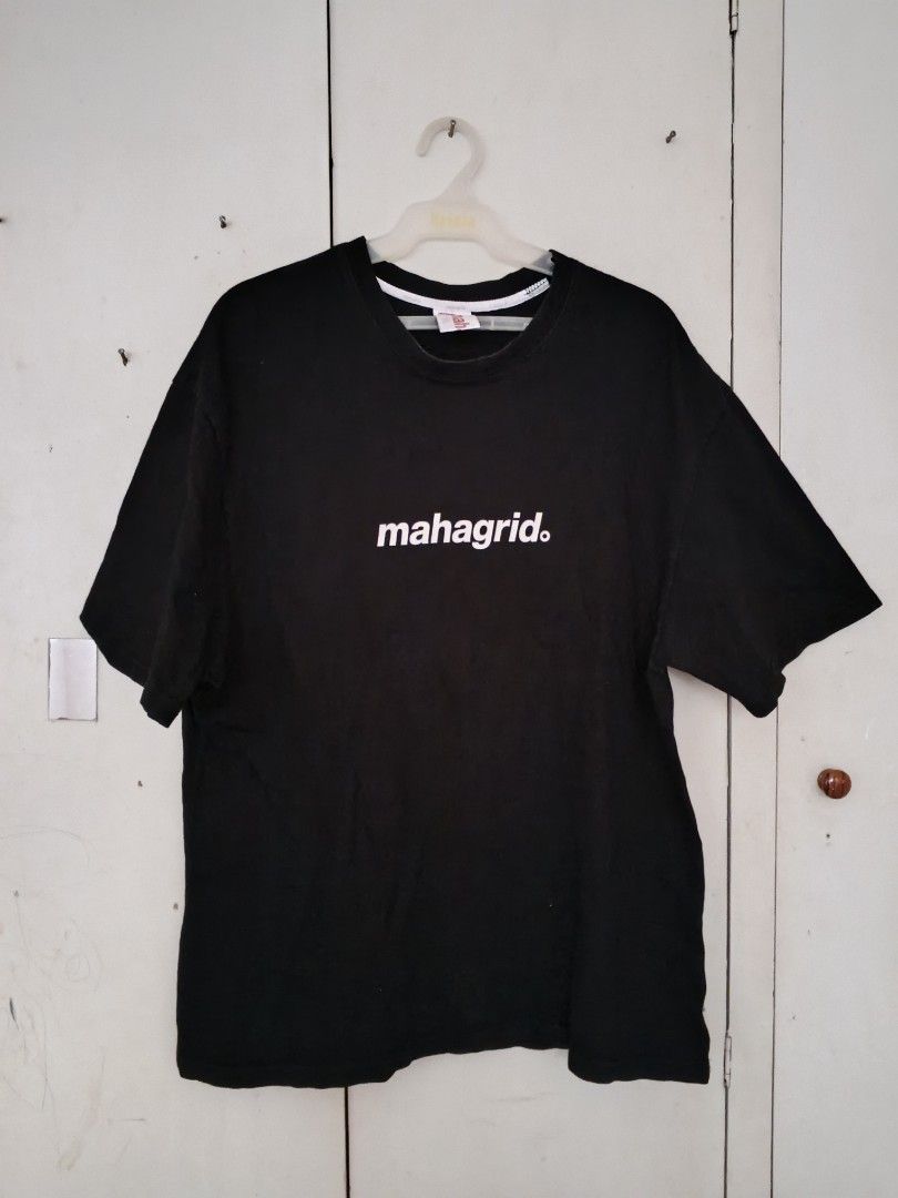 Mahagrid Black T-shirt (Category: Tshirts & Polo Shirts ) located in Bacolod City. Submitted by cm.mdlynn (Listing ID 1431594484, Image 1). Description: Black Mahagrid T-shirt with a white logo on the front. The shirt has a crew neck and short sleeves. The tag shows the brand name and "DESIGN LABEL"..