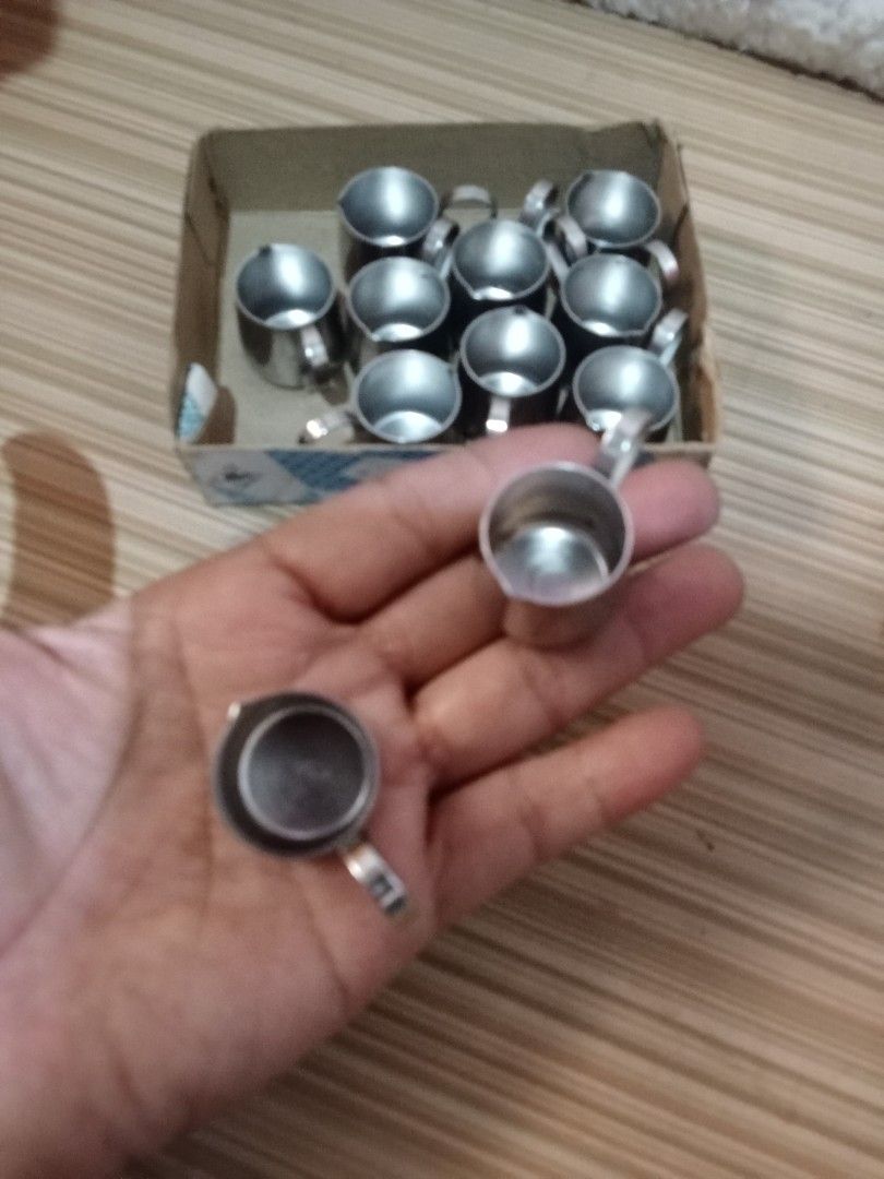 Miniature Stainless Steel Cups (Category: Coffee & Tea Tableware) located in Bocaue. Submitted by marajapansurplus (Listing ID 1431602062, Image 3). Description: - Set of miniature stainless steel cups - Each cup has a small handle - Comes in a cardboard box with Japanese text - Cups appear unused - Ideal for small servings or decorative use.