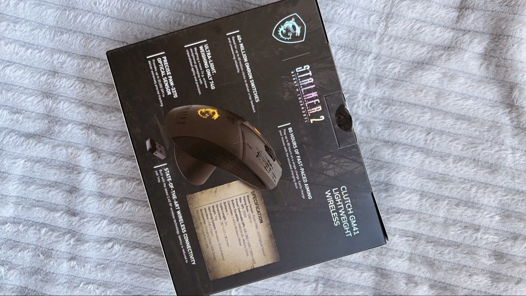 MSI Clutch GM41 Lightweight Wireless Mouse (STALKER 2 Edition) (Category: Mouse & Mousepads) located in Manila. Submitted by arghelicuh (Listing ID 1431675038, Image 2). Description: - MSI Clutch GM41 Lightweight Wireless Mouse - Stalker 2 Theme - Ultra-lightweight design - 60+ million Omron switches - PAW-3370 optical sensor for precise tracking - Up to 80 hours of battery life on a single charge.