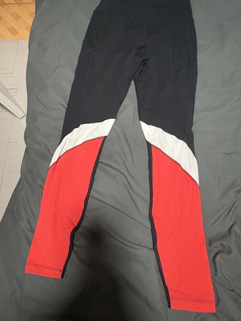 Nike Dri-FIT Leggings - Small (Category: Activewear) located in San Pedro. Submitted by kitdj (Listing ID 1431660299, Image 3). Description: - Nike Dri-FIT leggings - Color: Black with white and red accents - Size: Small - Features: Side pocket, mesh detail on white panels - Nike logo and Dri-FIT label - Made in Sri Lanka.