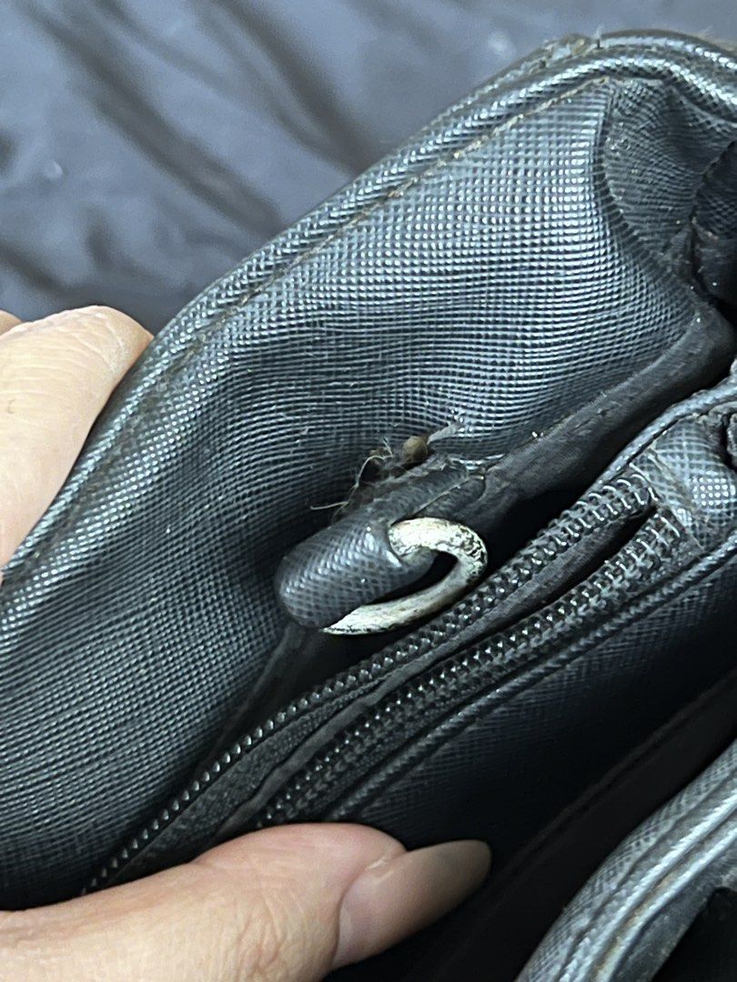 Nine West Black Handbag (Category: Luxury Bags & Wallets) located in Makati City. Submitted by tilli28 (Listing ID 1431578842, Image 3). Description: - Nine West black handbag - Top handles - Front zipper pocket - Silver-tone logo plate - Interior shows wear and tear - Damage on handles and lining - Functional for everyday use.