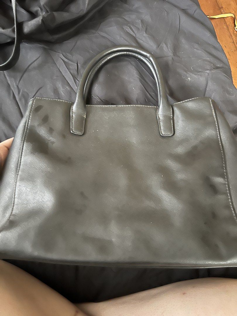 Nine West Black Handbag (Category: Luxury Bags & Wallets) located in Makati City. Submitted by tilli28 (Listing ID 1431578842, Image 2). Description: - Nine West black handbag - Top handles - Front zipper pocket - Silver-tone logo plate - Interior shows wear and tear - Damage on handles and lining - Functional for everyday use.
