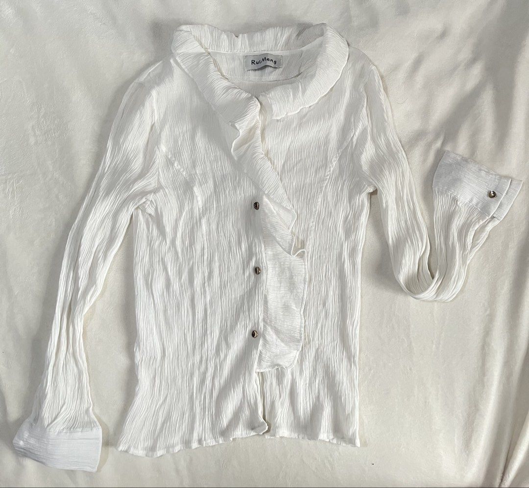 Office / Corporate White Ruffle Blouse Longsleeves (Category: Blouses) located in Mandaluyong City. Submitted by mandmclosey_ (Listing ID 1431659020, Image 1). Description: - RuiMeng white blouse - Ruffled front and collar - Long sleeves with flared cuffs - Button closures - Textured fabric - Measurements: - Length: 22 inches - Width: 13 inches - Sleeves: 22 inches Loc: Mandaluyong City Mode of payment: Gcash only!! Mode of delivery: lalamove/ang