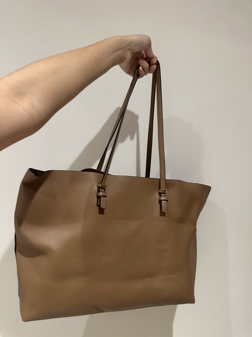 Parfois Tan Tote bag (Category: Tote Bags) located in Quezon City. Submitted by adc2011 (Listing ID 1431775427, Image 3). Description: - Tan tote bag - Long shoulder straps - Spacious interior - Rectangular shape - Made of leather-like material - Suitable for everyday use - Classic and versatile style.