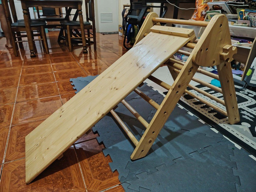 Pikler Triangle (Category: Infant Playtime) located in Manila. Submitted by justmever01572 (Listing ID 1431667176, Image 2). Description: Wooden climbing triangle for toddlers. Sturdy design with climbing rungs and a reversible ramp for sliding/climbing. Promotes physical activity and gross motor skills..