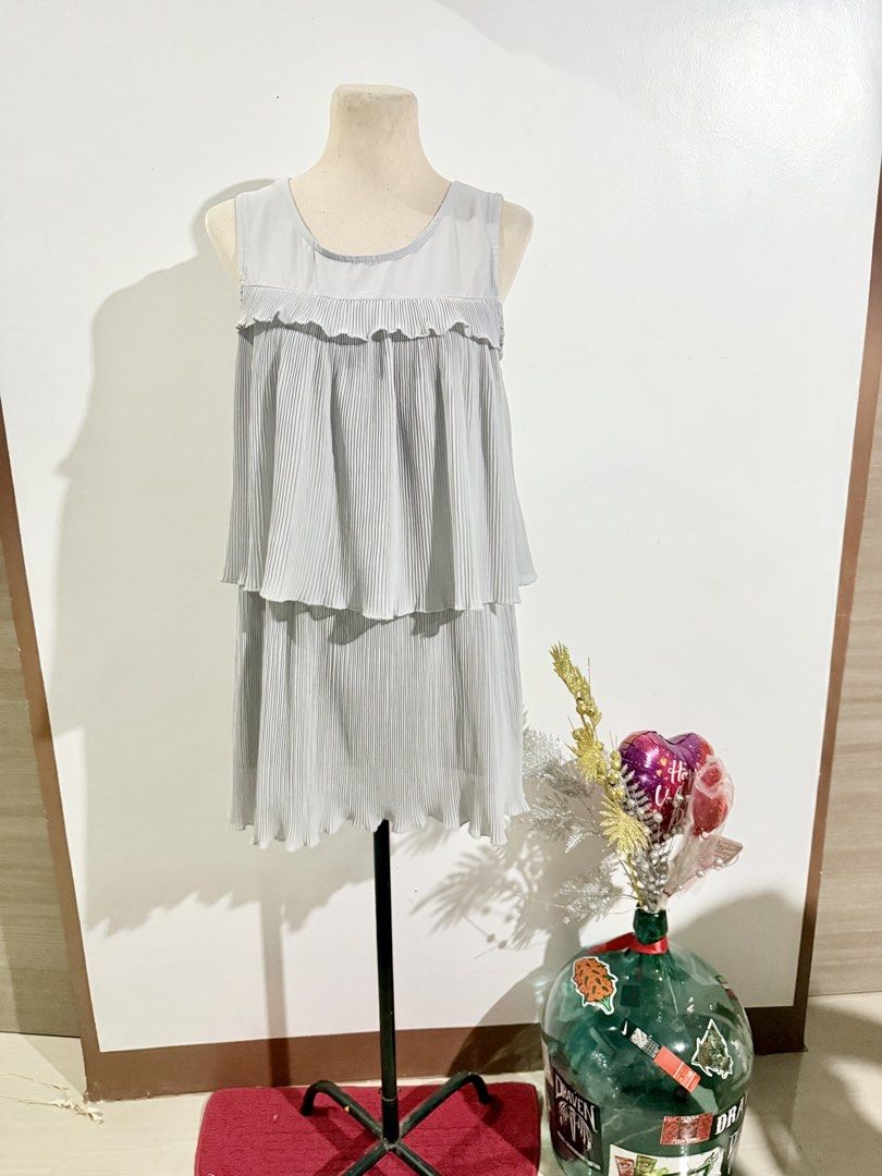 Pleated Layered Dress (Category: Dresses) located in Caloocan City. Submitted by dddddddddddeclutter (Listing ID 1431758974, Image 1). Description: - Light gray mini dress - Pleated design with layered details - Sleeveless cut - Round neckline - Ideal for casual wear and summer outings.